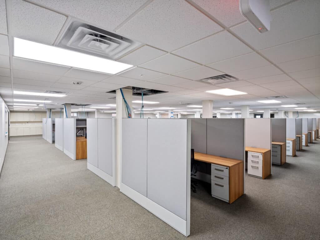 Main-floor offices with furnished cubicles in the two-story modular office building
