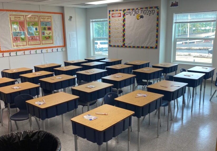 Interior of a single story modular classroom with student desks neatly arranged in a portable modular classroom building