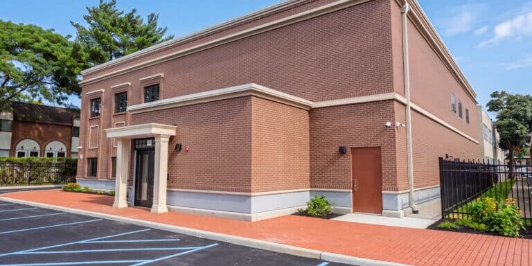 Two-story permanent modular school building for Kulanu in Cedarhurst, NY, brick exterior with entrance portico side