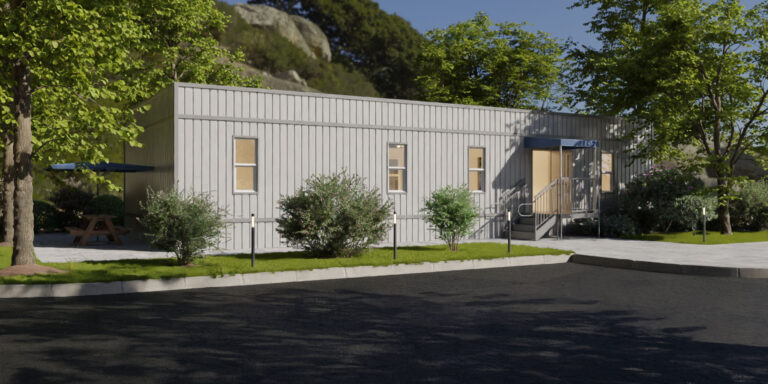 Modular office trailer surrounded by trees and bushes